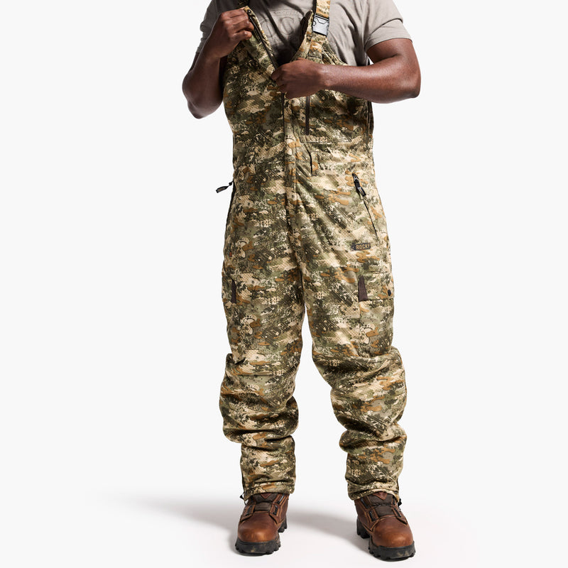 Person wearing camouflage overalls on a white background