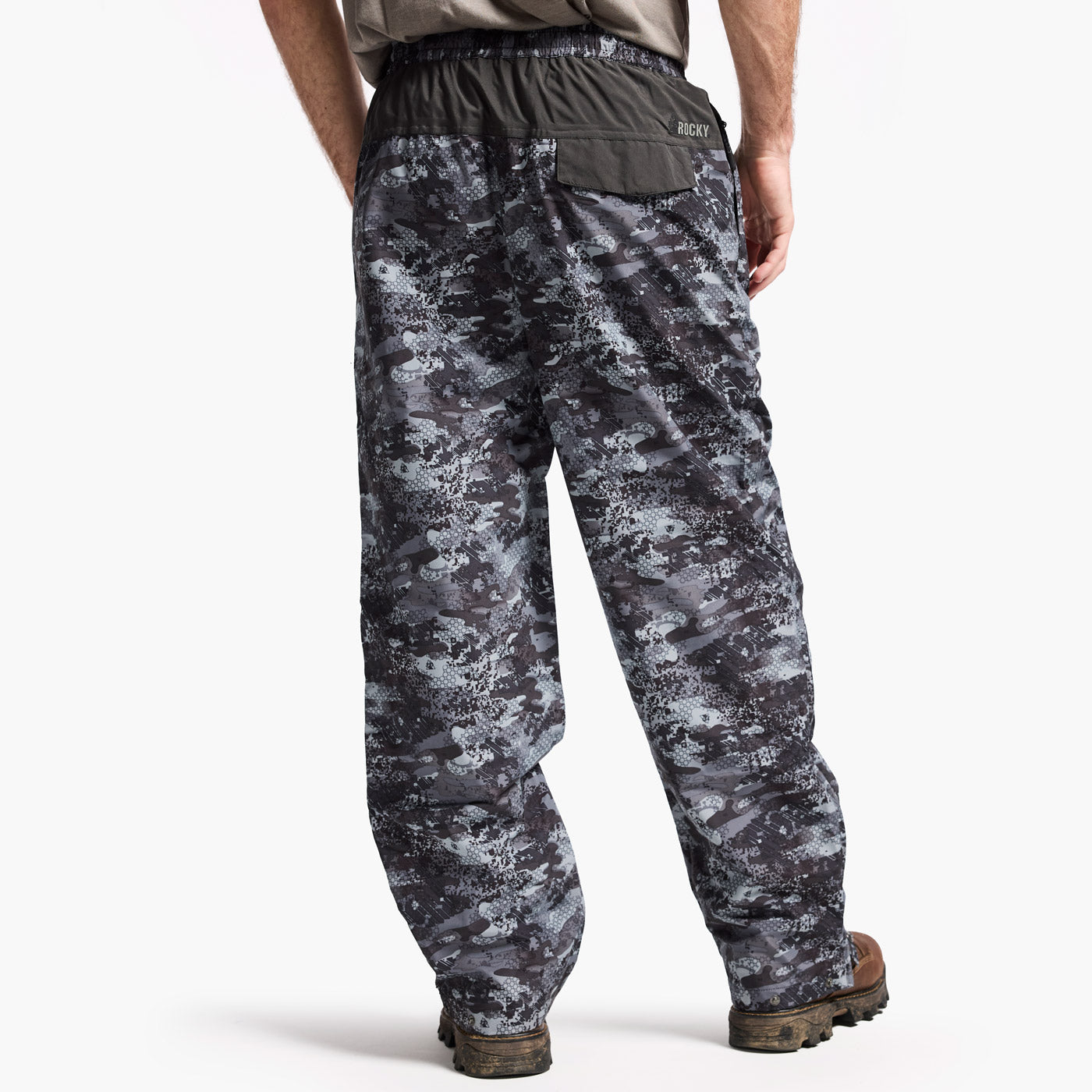 Camouflage pants worn by a person on a white background