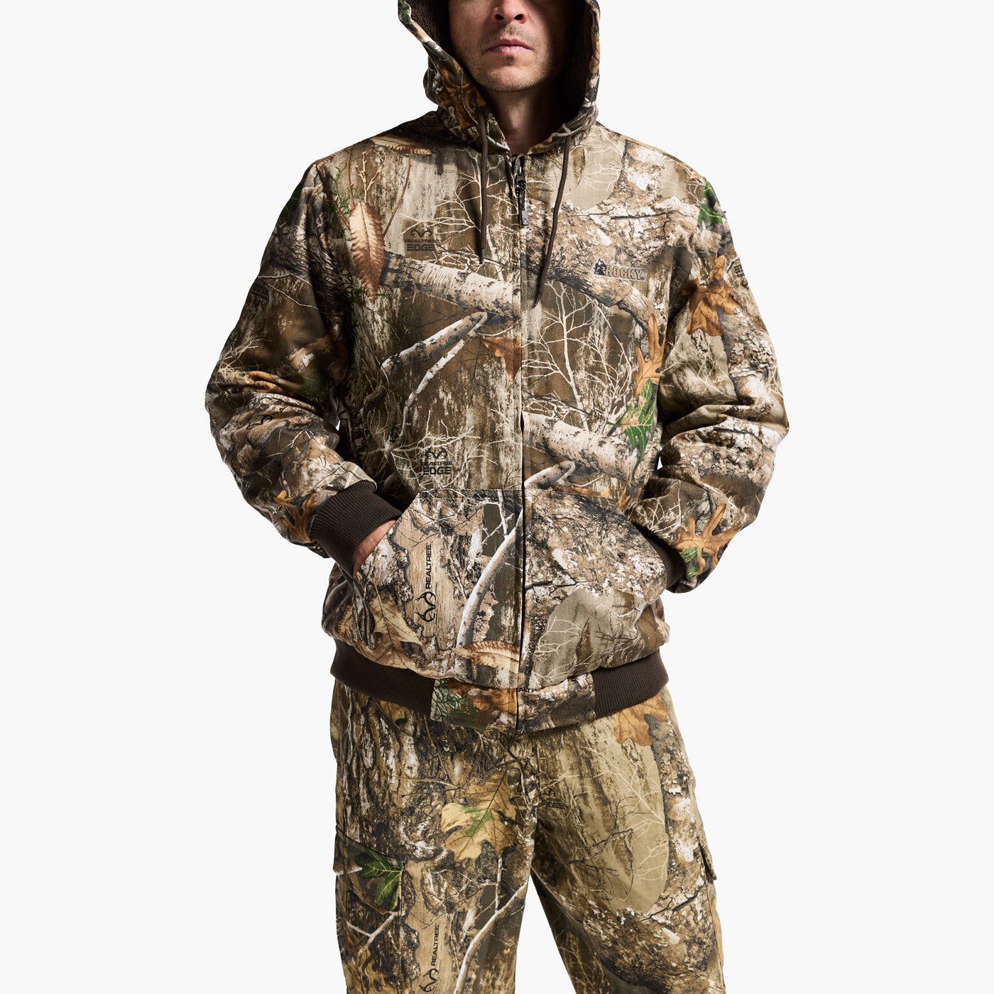 Camouflage hoodie and pants worn by a person on a white background