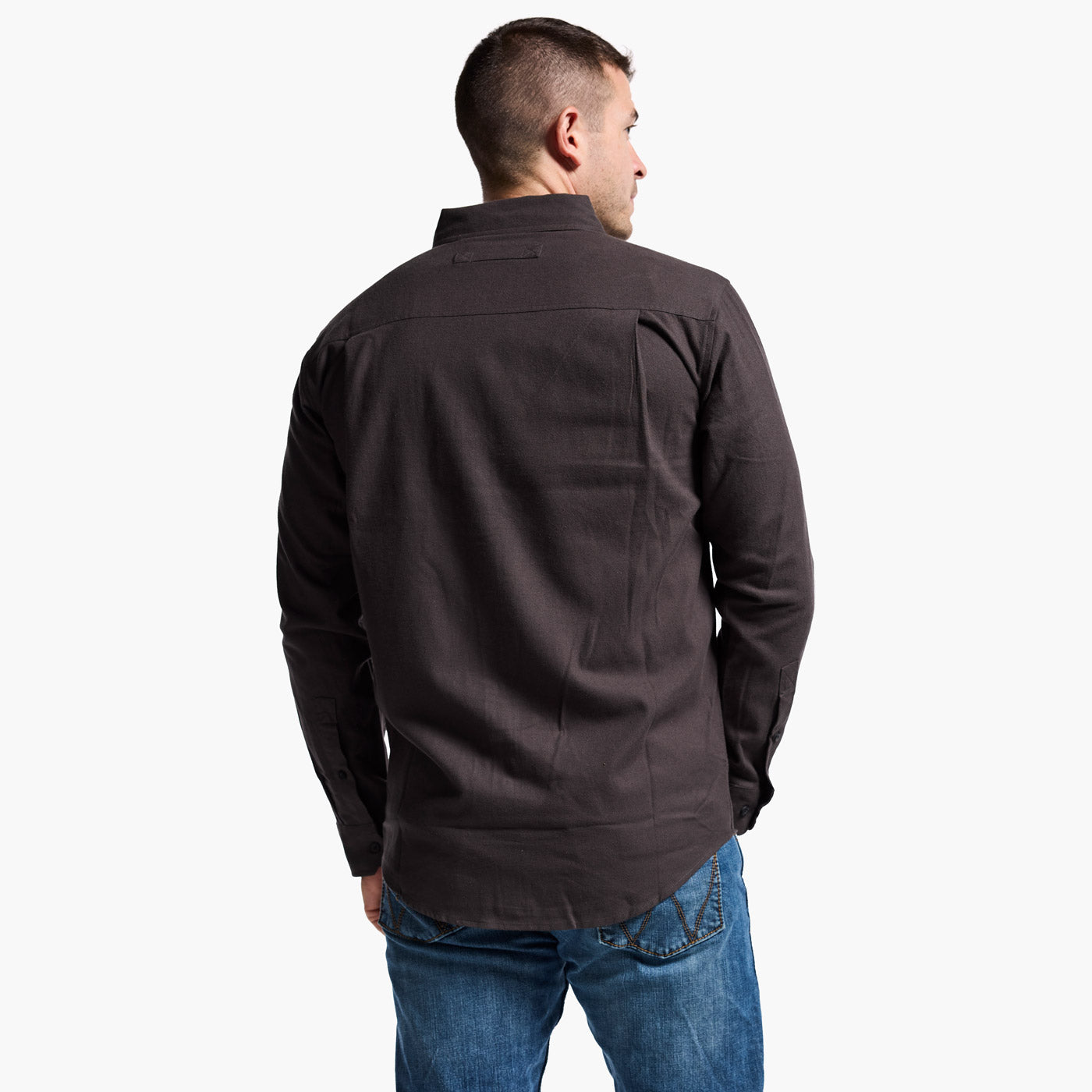 Man wearing a dark jacket and blue jeans on a white background